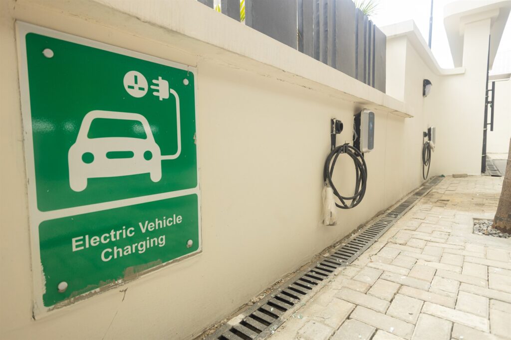 Brum Height 7: Wall-mounted electric vehicle charger and charging-bay sign